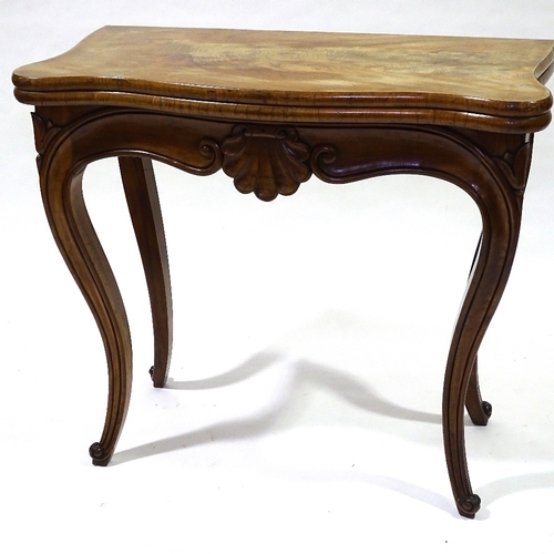 442 - A 19th century walnut fold over card with carved frieze and cabriole legs, width 83cm