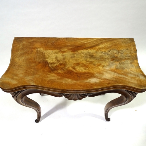 442 - A 19th century walnut fold over card with carved frieze and cabriole legs, width 83cm