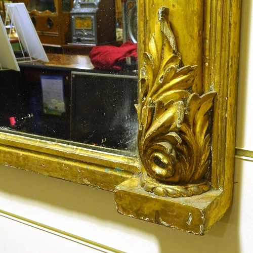 134 - A 19th century carved giltwood framed overmantle mirror with acanthus pediment, width excluding leaf... 