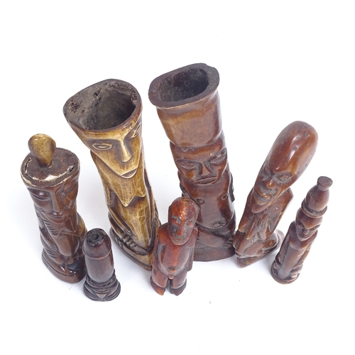 12 - A group of 19th century African Tribal carved and stained ivory and bone figures, probably Lega, inc... 