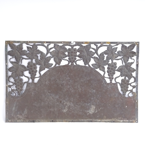 25 - An Art Nouveau copper door pediment, pierced grapevine decoration and planished central panel, lengt... 