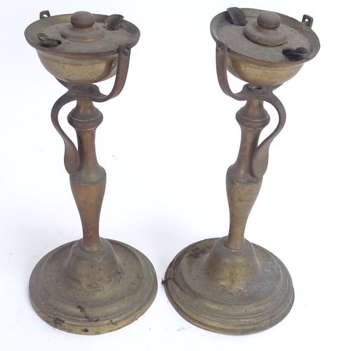 44 - A pair of nautical brass swivel candlesticks/oil burners, height 25cm