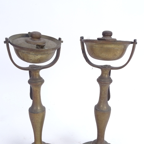 44 - A pair of nautical brass swivel candlesticks/oil burners, height 25cm