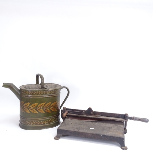 52 - A painted and gilded bargeware tin water can, and a cast-iron paper guillotine, can height 34cm (2)