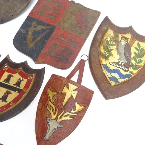 63 - A collection of carved and painted wood armorial plaques, largest height 30cm