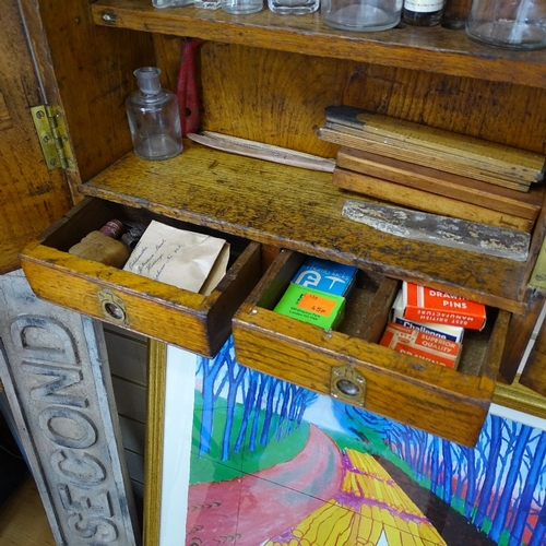 91 - A Victorian panelled oak carpenter's tool cabinet, with label for Sheffield Works, and some tools