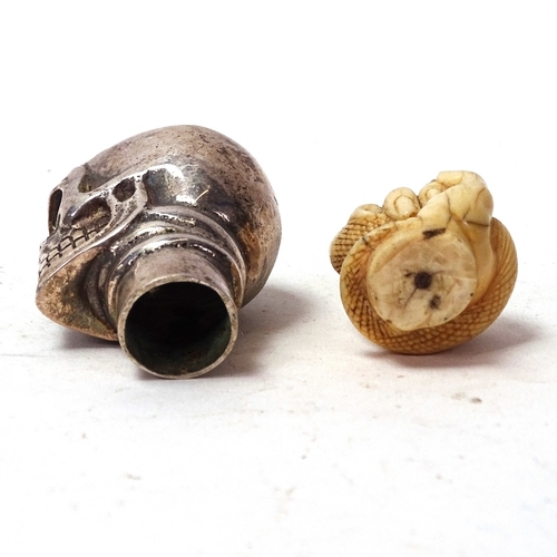 99 - A 19th century carved ivory hand holding snake parasol handle tip, and a silver plated skull walking... 