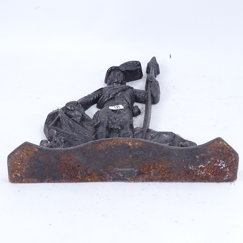 191 - A large black painted cast-iron figural doorstop, depicting guard leaning on rocks, overall height 3... 