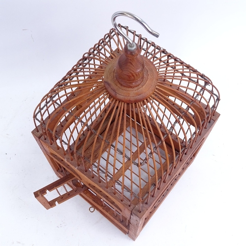 208 - A small gilded wirework beehive-shape hanging bird cage, and a bent hardwood dome-top hanging bird c... 