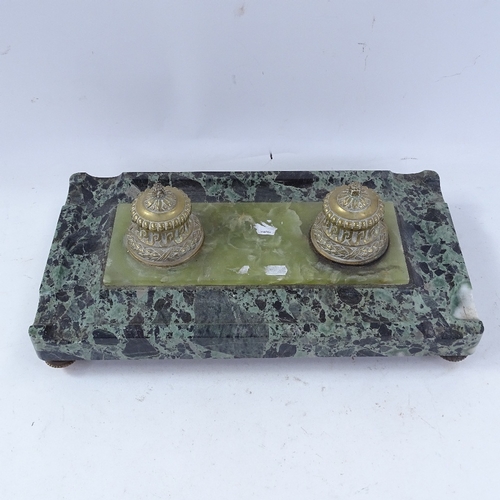 224 - A large polished green marble desk stand, with double brass inkwells and inset central onyx panel, o... 