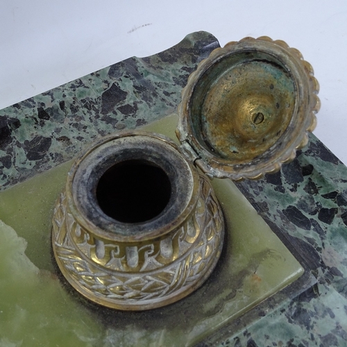 224 - A large polished green marble desk stand, with double brass inkwells and inset central onyx panel, o... 