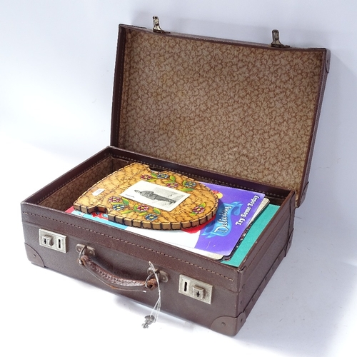 228 - A leather-bound briefcase, containing Enid Blyton books, modern signs etc