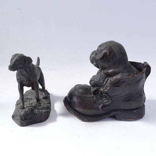 231 - A pair of composition lion-head bookends, resin Pointer dog sculpture, and resin dog in shoe sculptu... 