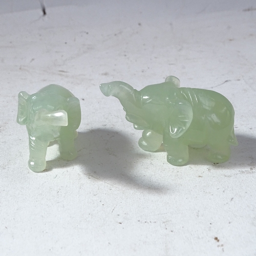 232 - A modern set of carved and polished jade elephants, on fitted display stand with original box