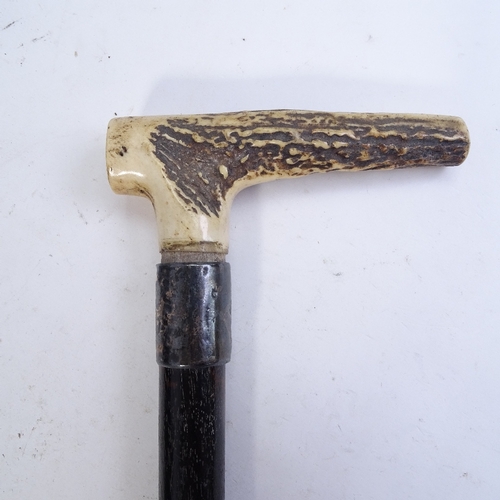 244 - A Vintage snakeskin-handled parasol, and a stag horn-handled ebony walking cane with silver collar (... 