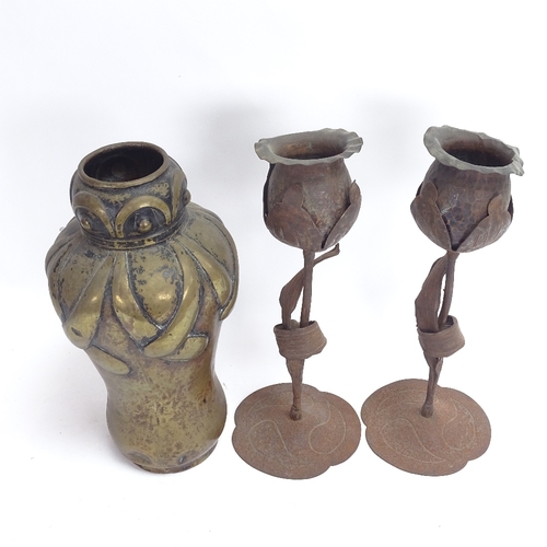 65 - A pair of German Arts and Crafts Hugo Goberg iron tulip candleholders, and an Art Nouveau trench art... 