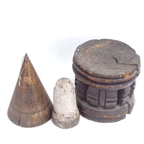 66 - An African Tribal carved and stained hardwood stool, an 18th century carved stone corn loft plug, an... 