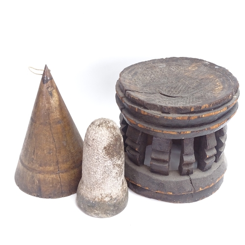 66 - An African Tribal carved and stained hardwood stool, an 18th century carved stone corn loft plug, an... 