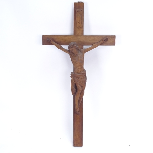 69 - A carved and stained oak crucifix, height 56cm