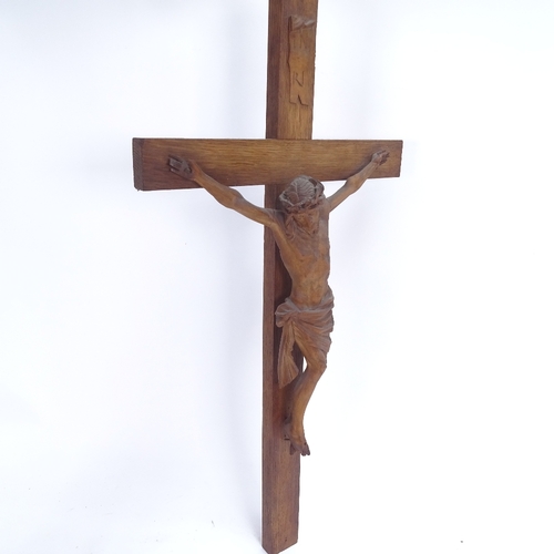 69 - A carved and stained oak crucifix, height 56cm