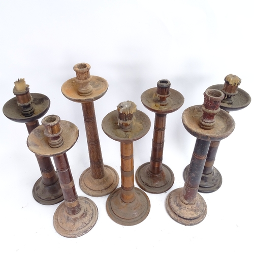 83 - Various turned wood copper-bound table candlesticks, largest height 44cm (7)