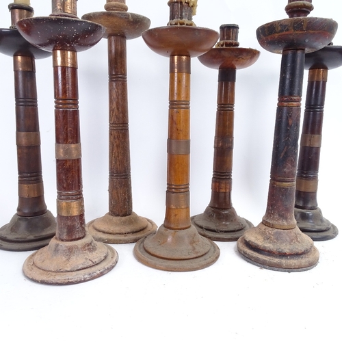 83 - Various turned wood copper-bound table candlesticks, largest height 44cm (7)