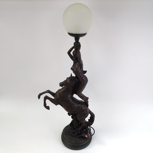 249 - A large resin figural table lamp, depicting nude figure standing on horseback, with crackle shade, o... 