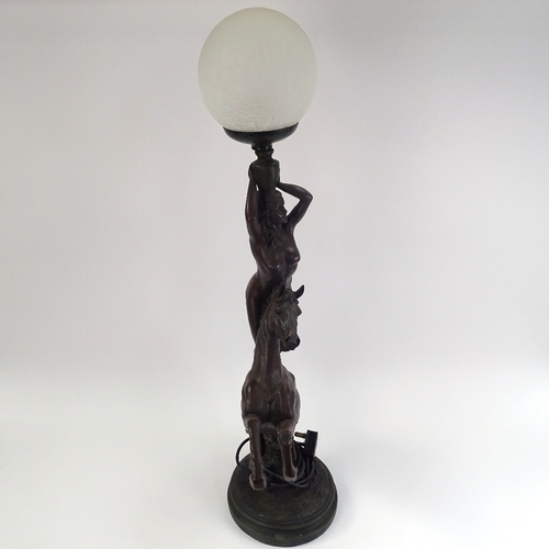 249 - A large resin figural table lamp, depicting nude figure standing on horseback, with crackle shade, o... 