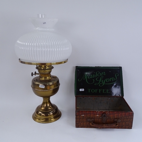 253 - A Vintage lithographed tin Maison Lyons Toffee briefcase box, and a brass oil lamp with milk glass s... 