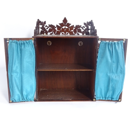 258 - A Black Forest style hanging display cabinet, with pierced oak leaf frieze and glazed doors, height ... 