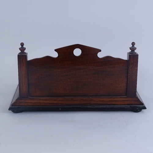 263 - An oak desk stand, with raised bevel-edge mirrored back, 2 inkwells and pen tray, stand length 30cm