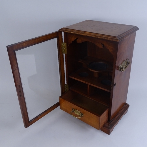 264 - A Victorian oak smoker's display cabinet, with brass swing handles, glazed door and fitted interior,... 