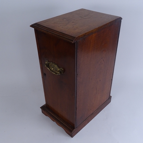 264 - A Victorian oak smoker's display cabinet, with brass swing handles, glazed door and fitted interior,... 