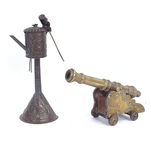 281 - A bronze and brass-mounted table cannon, and a brass oil burner (2)