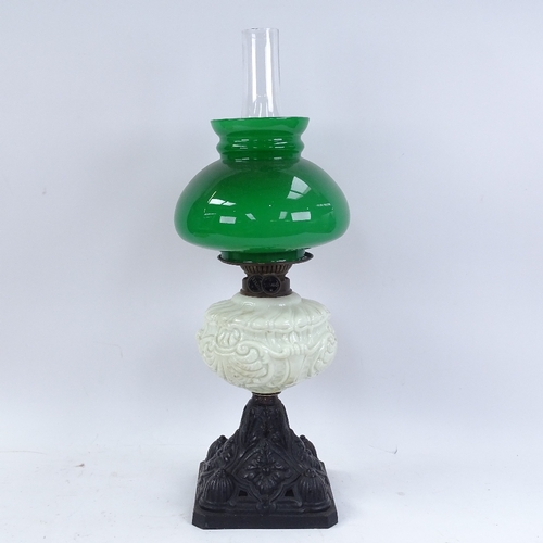 337 - A painted cast-iron oil lamp, with milk glass font, green shade and chimney, overall height 56cm