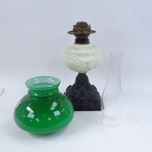 337 - A painted cast-iron oil lamp, with milk glass font, green shade and chimney, overall height 56cm