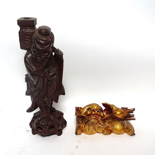 351 - A painted and gilded wood Dog of Fo carving, and a Chinese carved hardwood figure of a Sage, Sage he... 