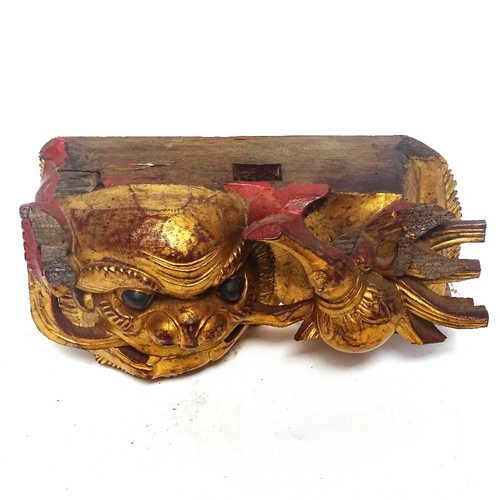 351 - A painted and gilded wood Dog of Fo carving, and a Chinese carved hardwood figure of a Sage, Sage he... 