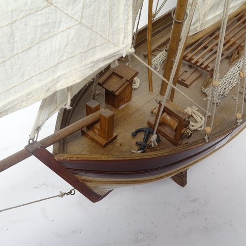 363 - A scratch-built wooden hull model boat, with sails and rigging, overall height 80cm