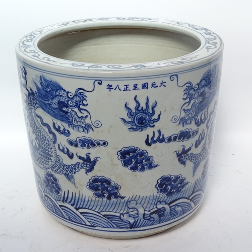 367 - A reproduction Chinese blue and white jardiniere with dragon decoration, height 30.5cm