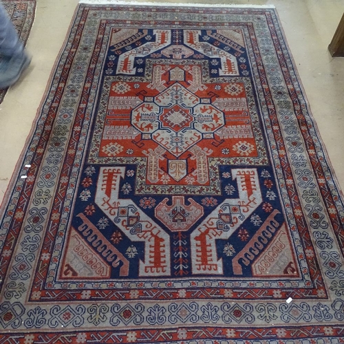 1539 - A blue and red ground Caucasian rug, 240cm x 150cm