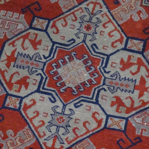 1539 - A blue and red ground Caucasian rug, 240cm x 150cm