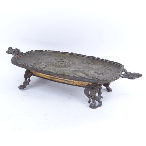 399 - A large cast-brass heraldic lion 2-handled table centre tray, central relief moulded panel with pier... 