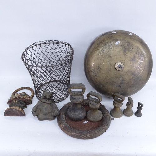 428 - Various cast-iron doorstops, a cast-brass framed circular mirror, and a large cast-brass domed gong