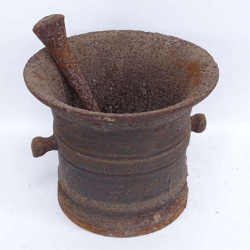 443 - A large 19th century cast-iron pestle and mortar, mortar height 25cm