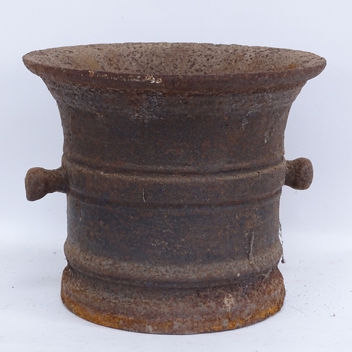 443 - A large 19th century cast-iron pestle and mortar, mortar height 25cm