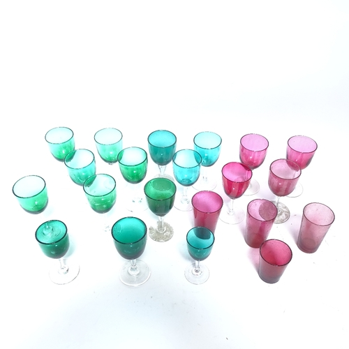 460 - A collection of various cranberry and green glass drinking glasses and beakers