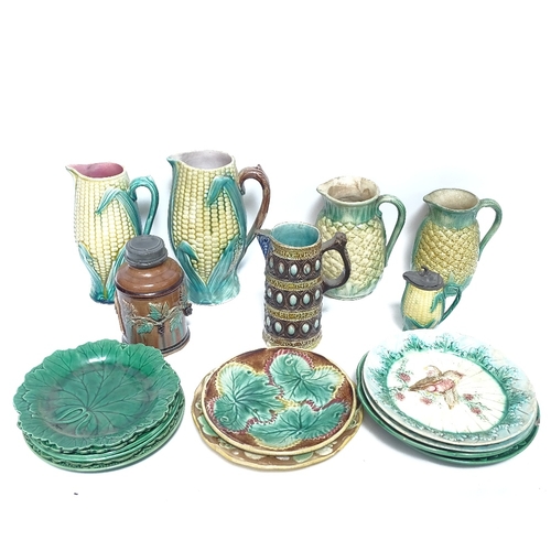 464 - A collection of Majolica ceramic jugs and plates, including corn on the cob and leaf plates