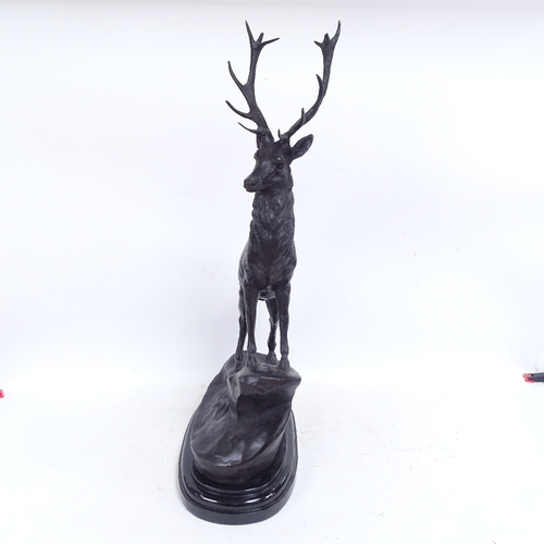 583 - After Joules Moigniez, a patinated bronze sculpture depicting stag on a rocky outcrop, on polished m... 