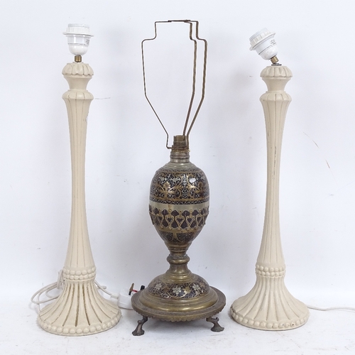 584 - A Middle Eastern brass and black enamel table lamp, and a pair of cream painted wood table lamps, br... 